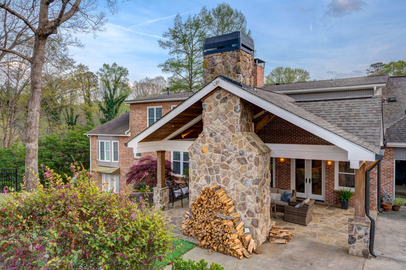 Backyard remodel with stacked wood and stone chimney by Silver Oak Remodeling in Atlanta, GA