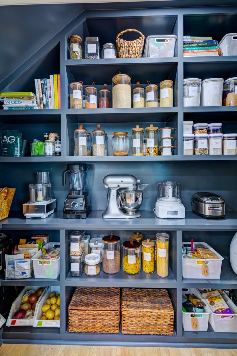 View of organized blue open shelving in walk-in pantry in kitchen remodel in Atlanta