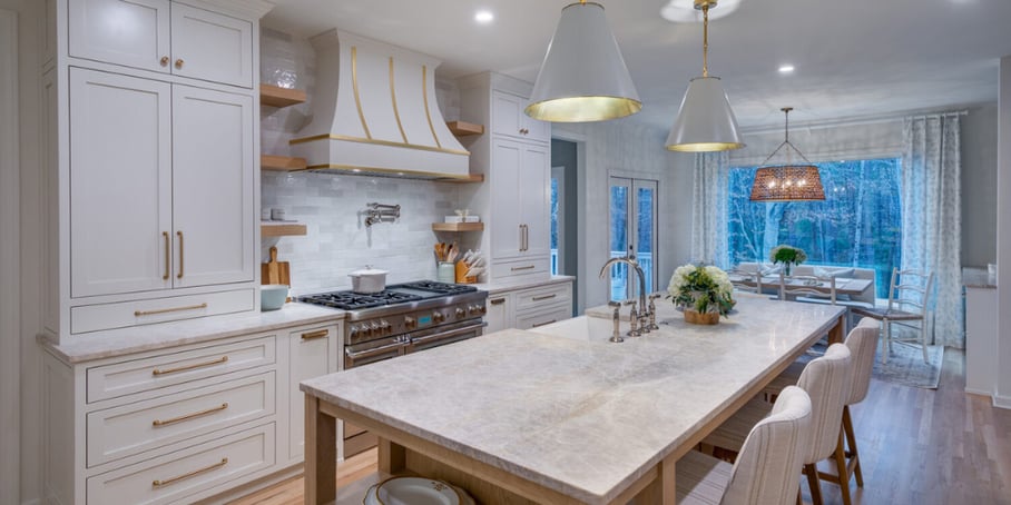 A remodeled kitchen in a North Atlanta home with an island-centric layout, pendant lights, and marble countertops