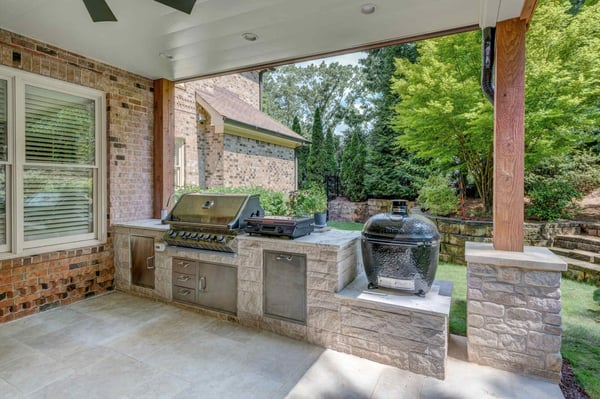 Covered outdoor kitchen with built-in grill and smoker by Silver Oak Remodel in Atlanta, GA