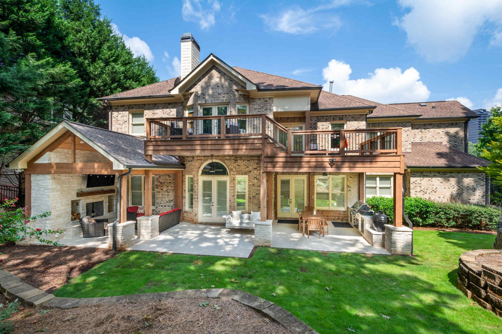 Custom brick home with upper and lower outdoor living spaces remodeled by Silver Oak Remodel in Atlanta, GA