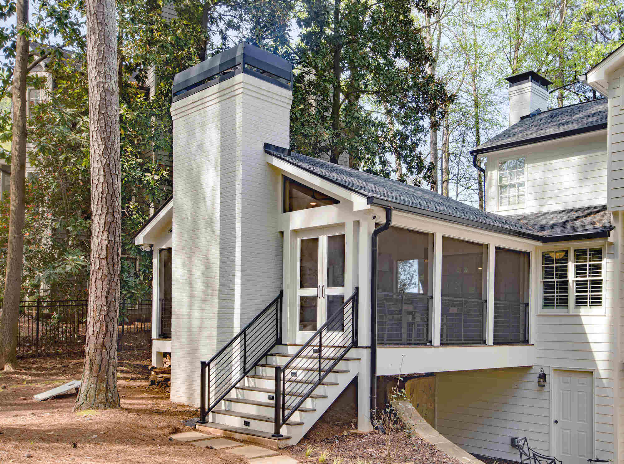 Exterior view of screened porch addition with brick fireplace by Silver Oak Remodel in Atlanta, GA
