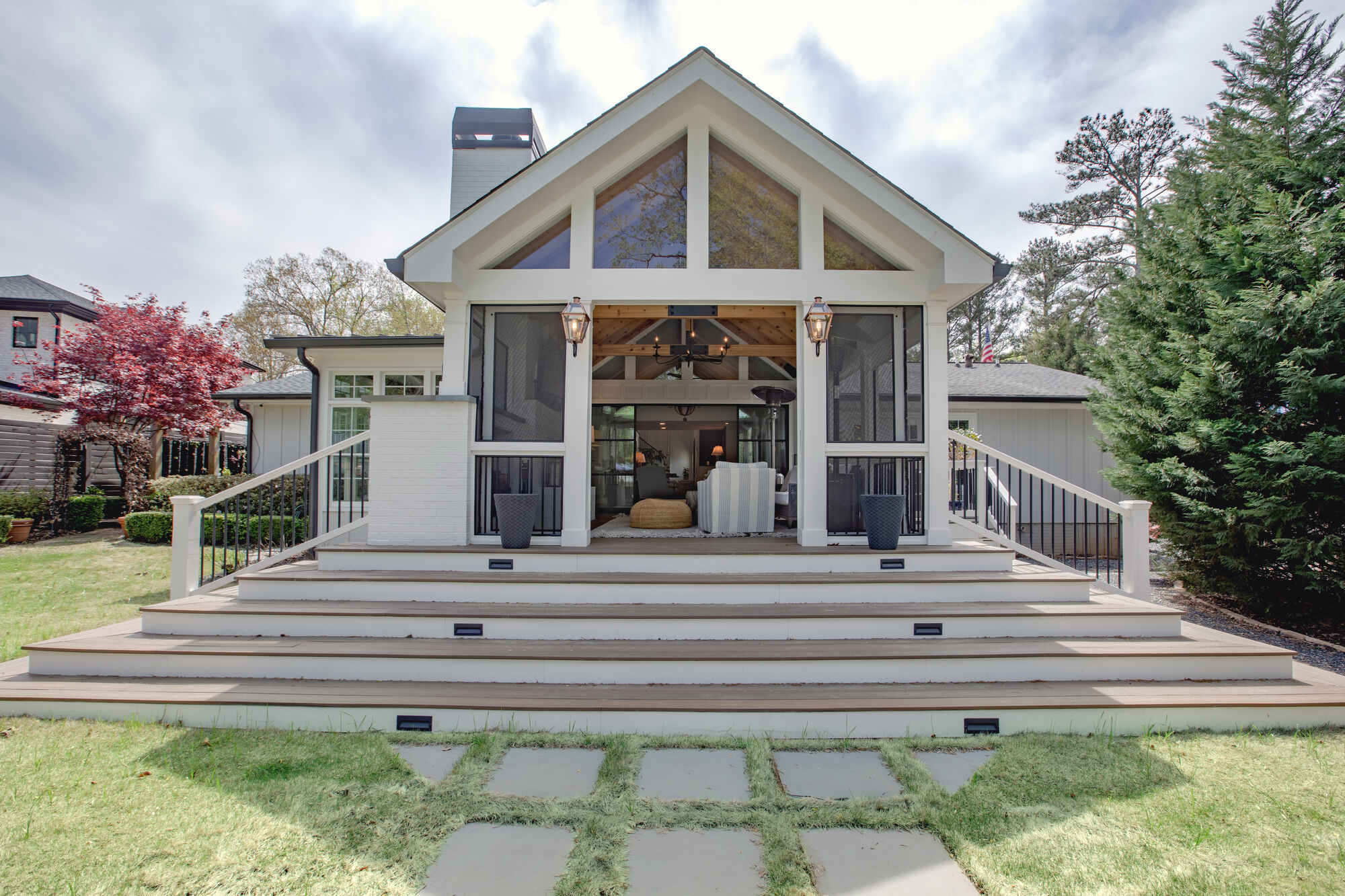 Rear view of custom porch addition with wide stairs and large windows by Silver Oak Remodel in Atlanta, GA