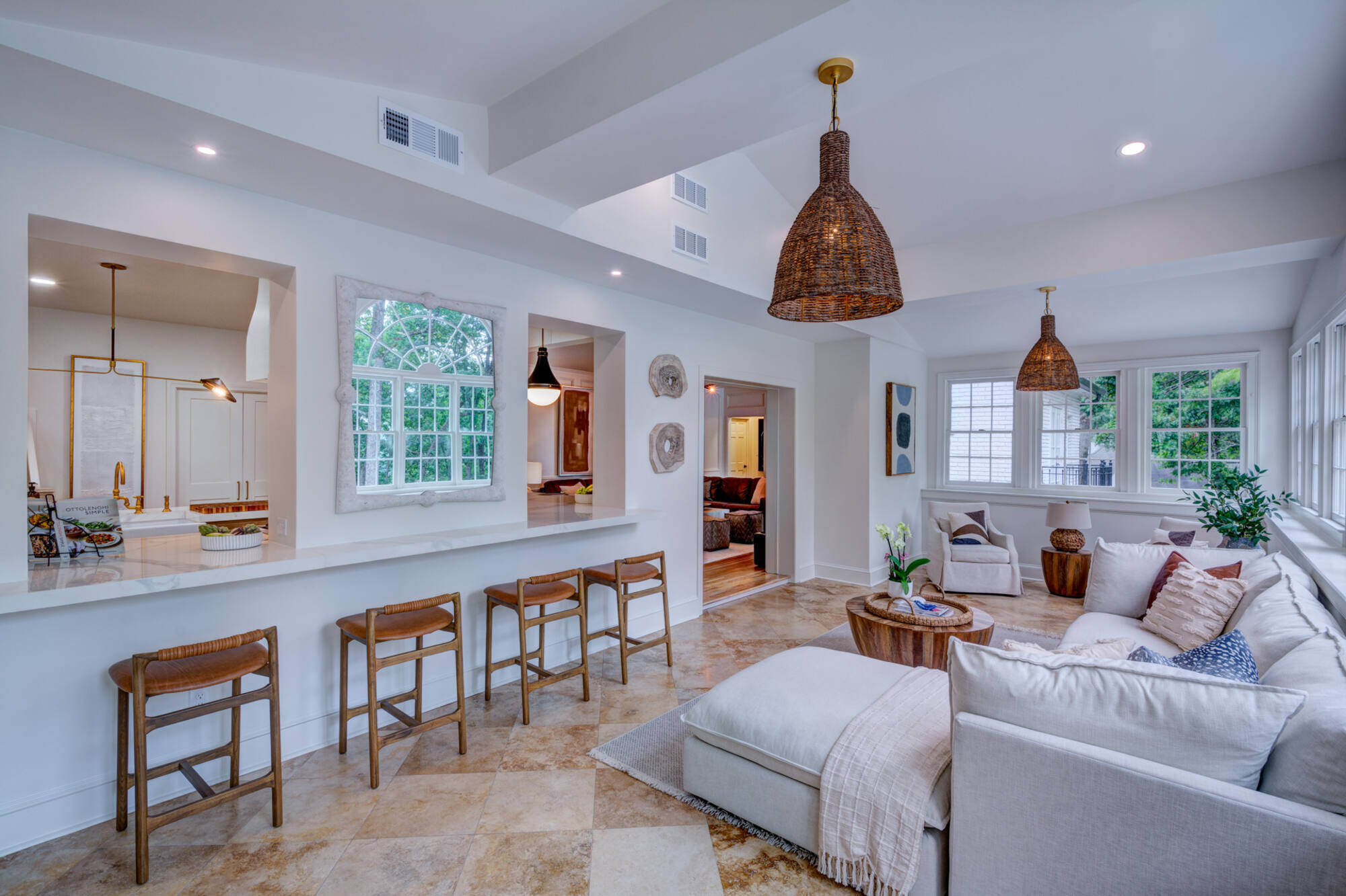 Spacious sunroom with bar seating and pendant lights by Silver Oak Remodel in Brookfield