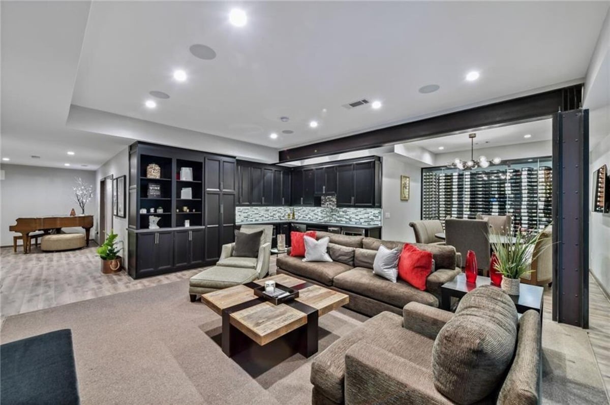 Basement entertainment area with lounge seating and built-in bar by Silver Oak Remodel in Atlanta, GA