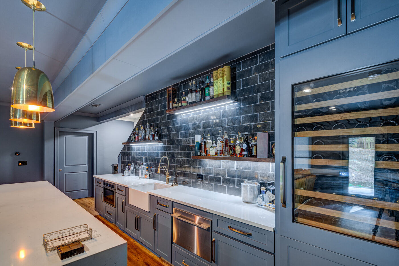 Basement entertainment space with full bar and seating area by Silver Oak Remodel in Atlanta, GA