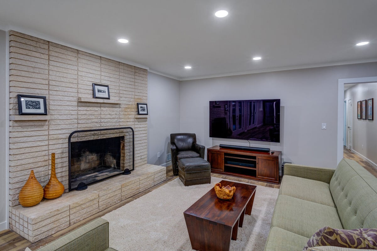 Basement family room with mounted TV and fireplace remodel in Atlanta GA by Silver Oak Remodel