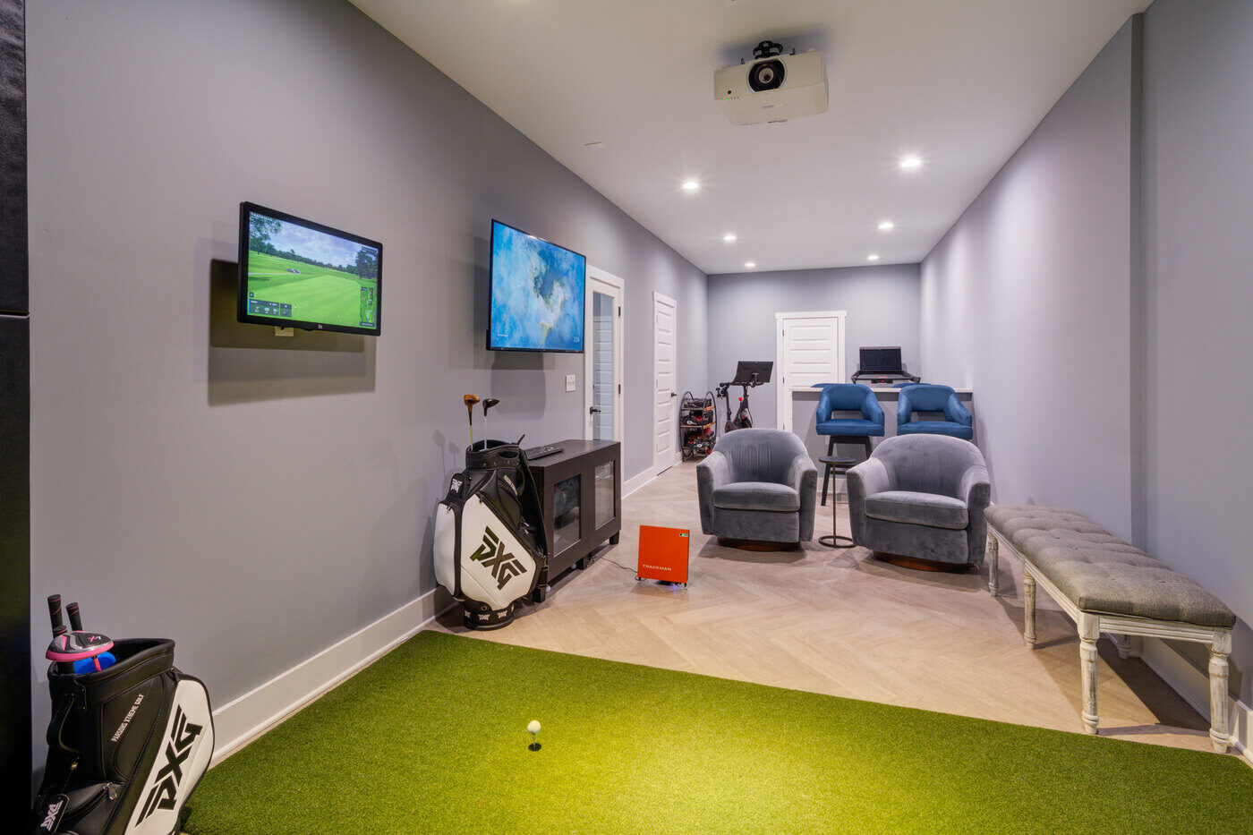 Basement golf simulator and lounge area in Atlanta remodel by Silver Oak Remodel