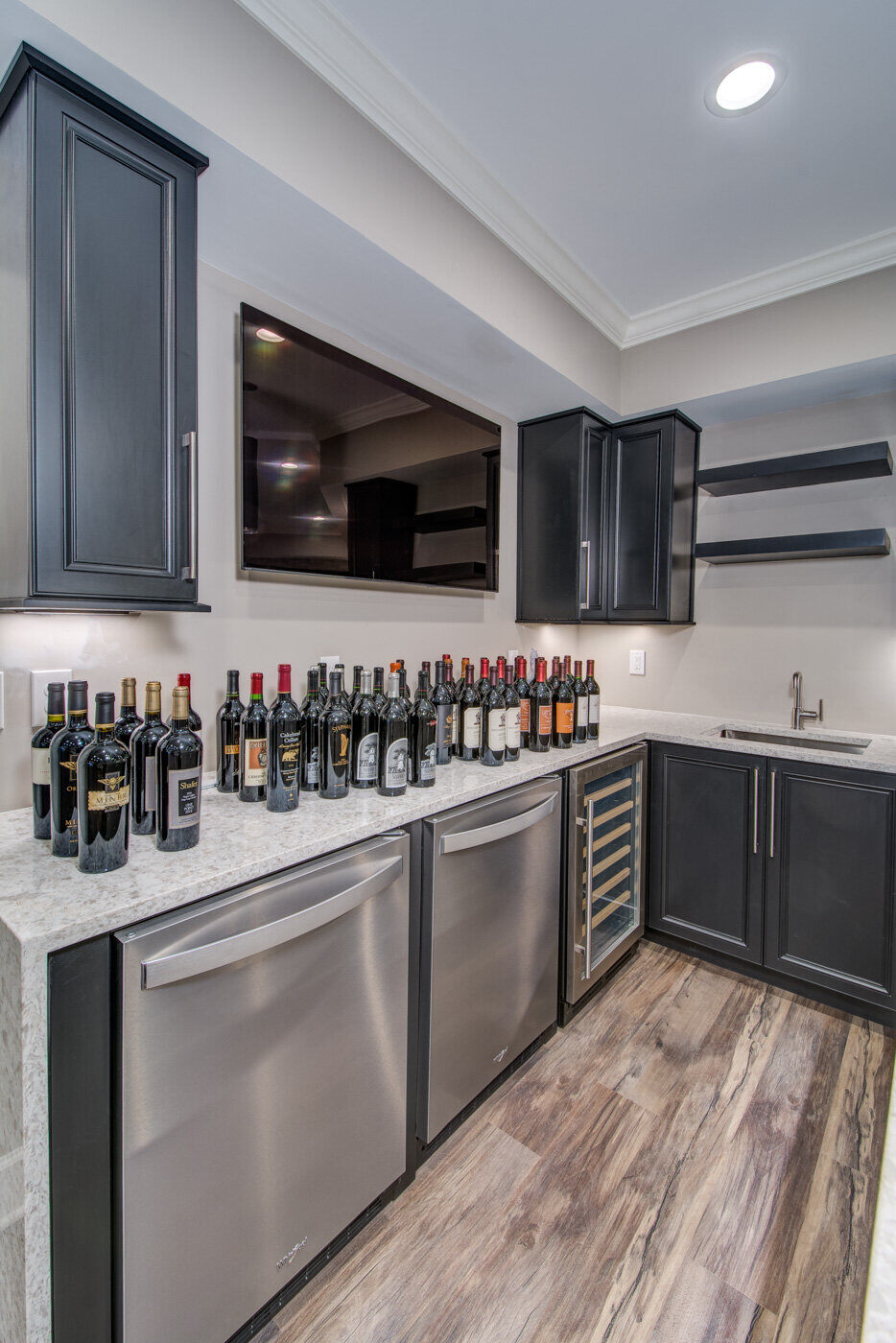 Basement home theater with large screen and bar counter by Silver Oak Remodel in Atlanta, GA
