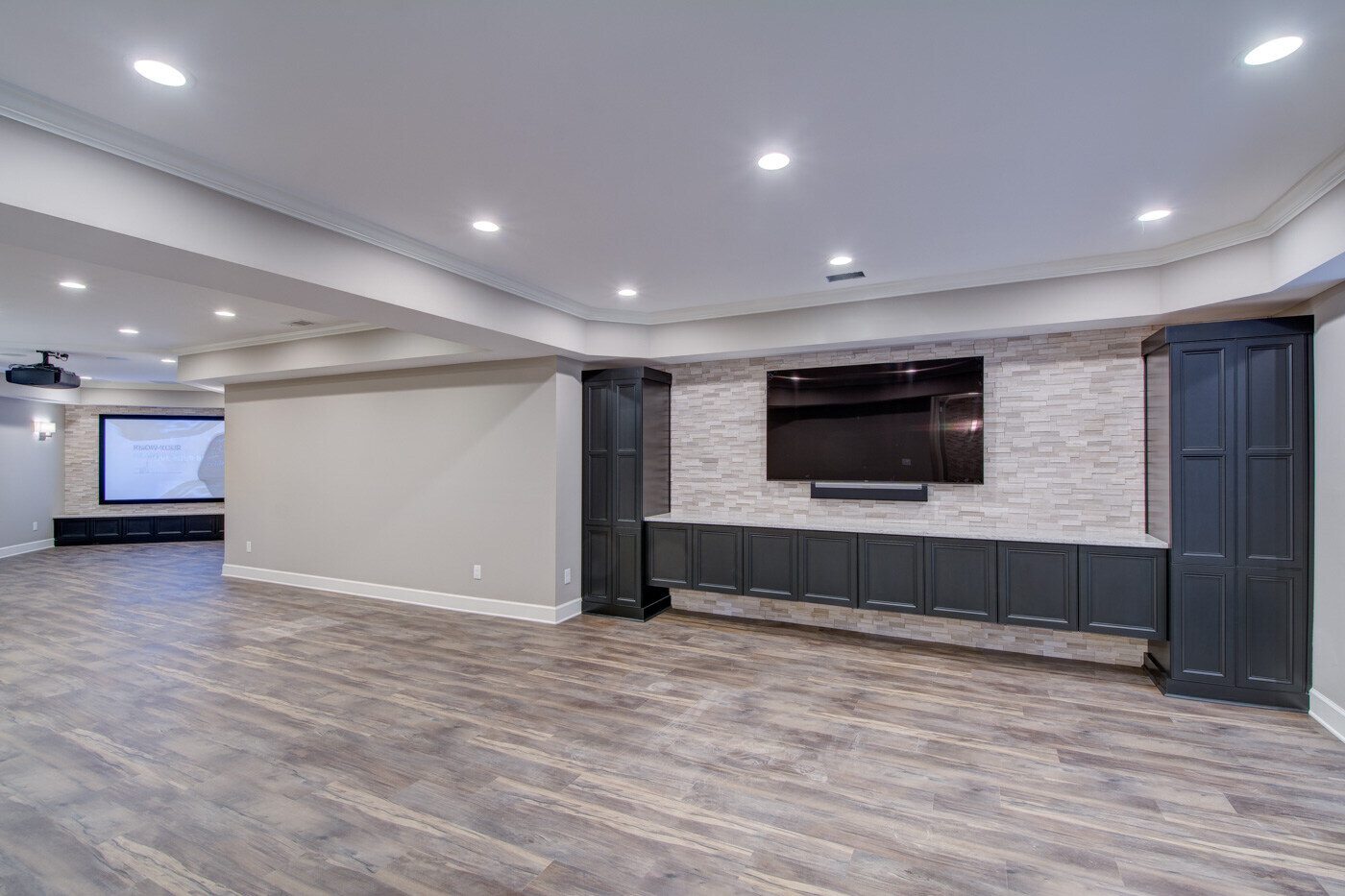 Basement living area with custom media wall remodel by Silver Oak Remodel in Atlanta, GA