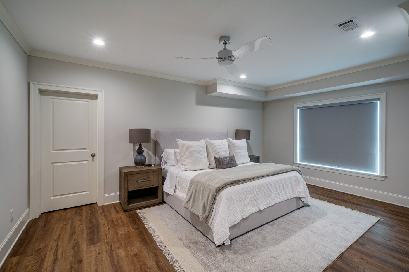Basement lounge with leather sectional and navy walls by Silver Oak Remodel in Atlanta, GA