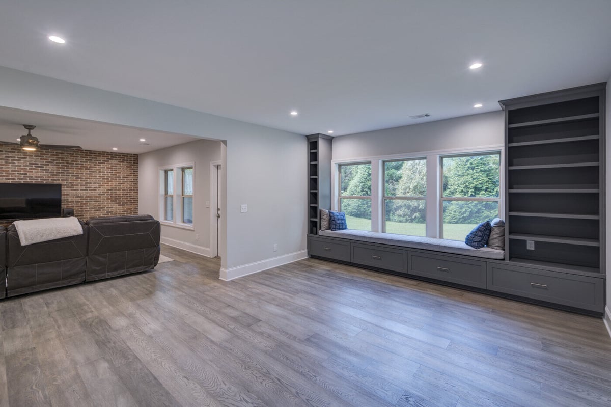 Basement remodel in Atlanta by Silver Oak Remodel with built-in window seat and adjacent TV lounge area