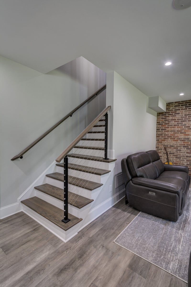 Basement stairs with cable railing and modern finishes in Atlanta remodel by Silver Oak Remodel