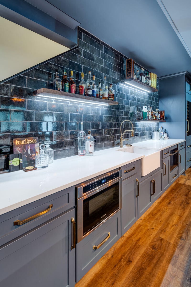Basement wet bar with wine storage and dark cabinetry by Silver Oak Remodel in Atlanta, GA