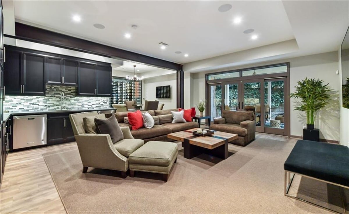 Cozy basement living room with bar and outdoor access by Silver Oak Remodel in Atlanta, GA