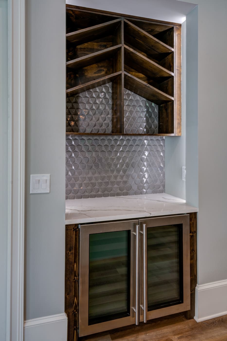 Custom wine bar nook with geometric tile backsplash and built-in wine fridge in an Atlanta, GA custom home by Silve