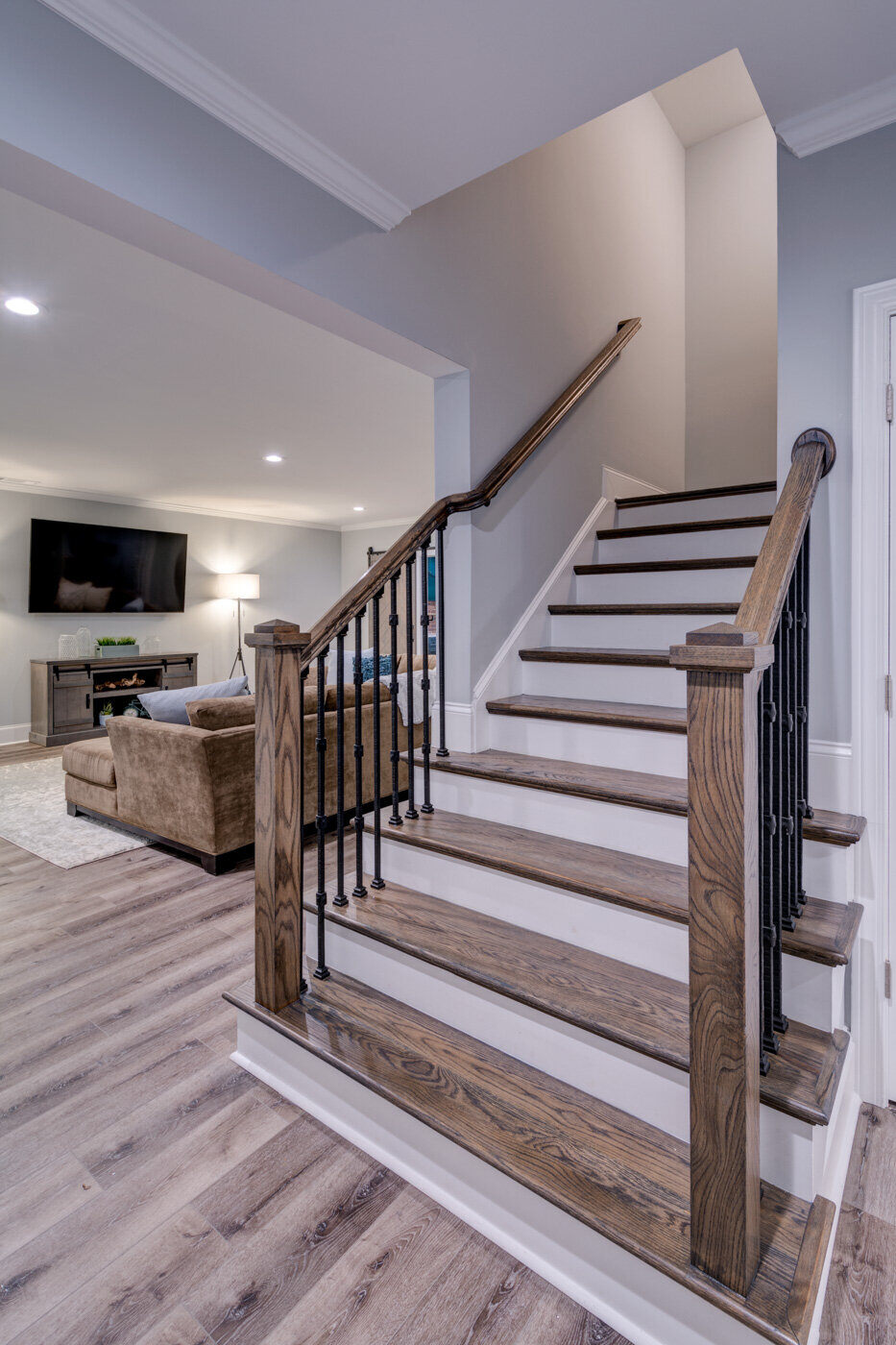 Hardwood staircase in remodeled Atlanta basement by Silver Oak Remodel leading to main level