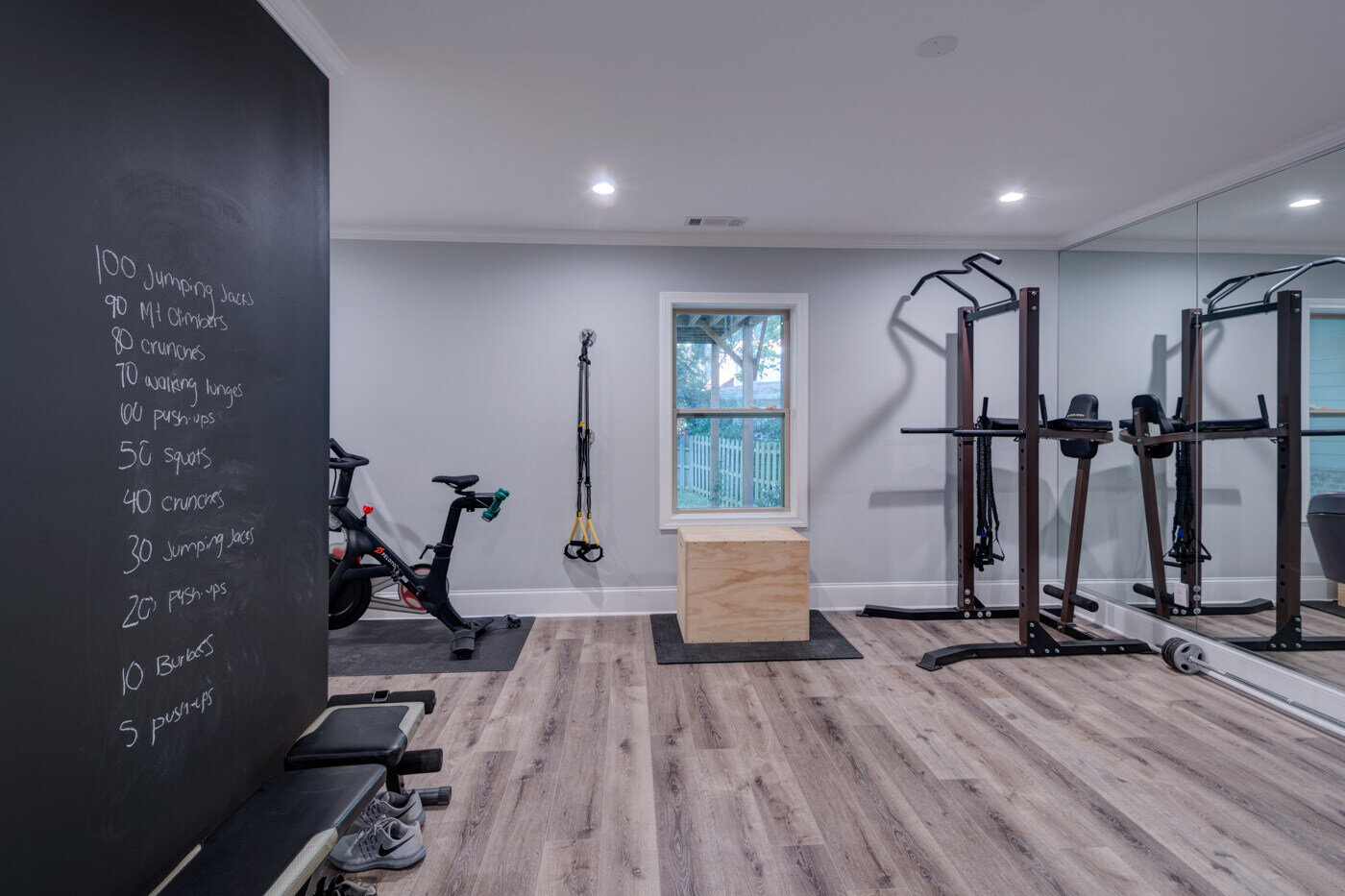 Home gym in Atlanta basement remodel by Silver Oak Remodel with equipment and chalkboard wall
