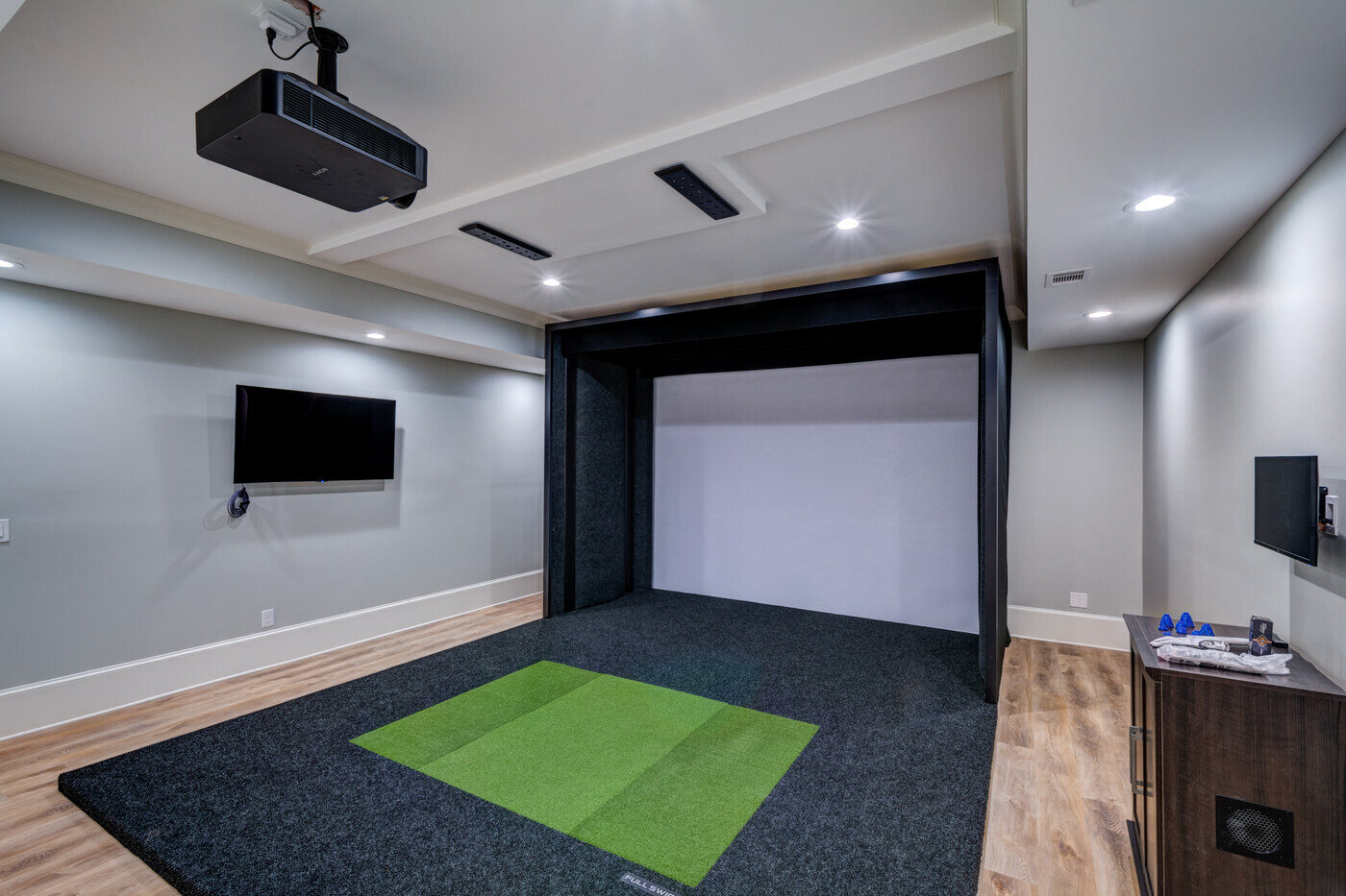 Indoor golf simulator in finished basement by Silver Oak Remodel in Atlanta, GA