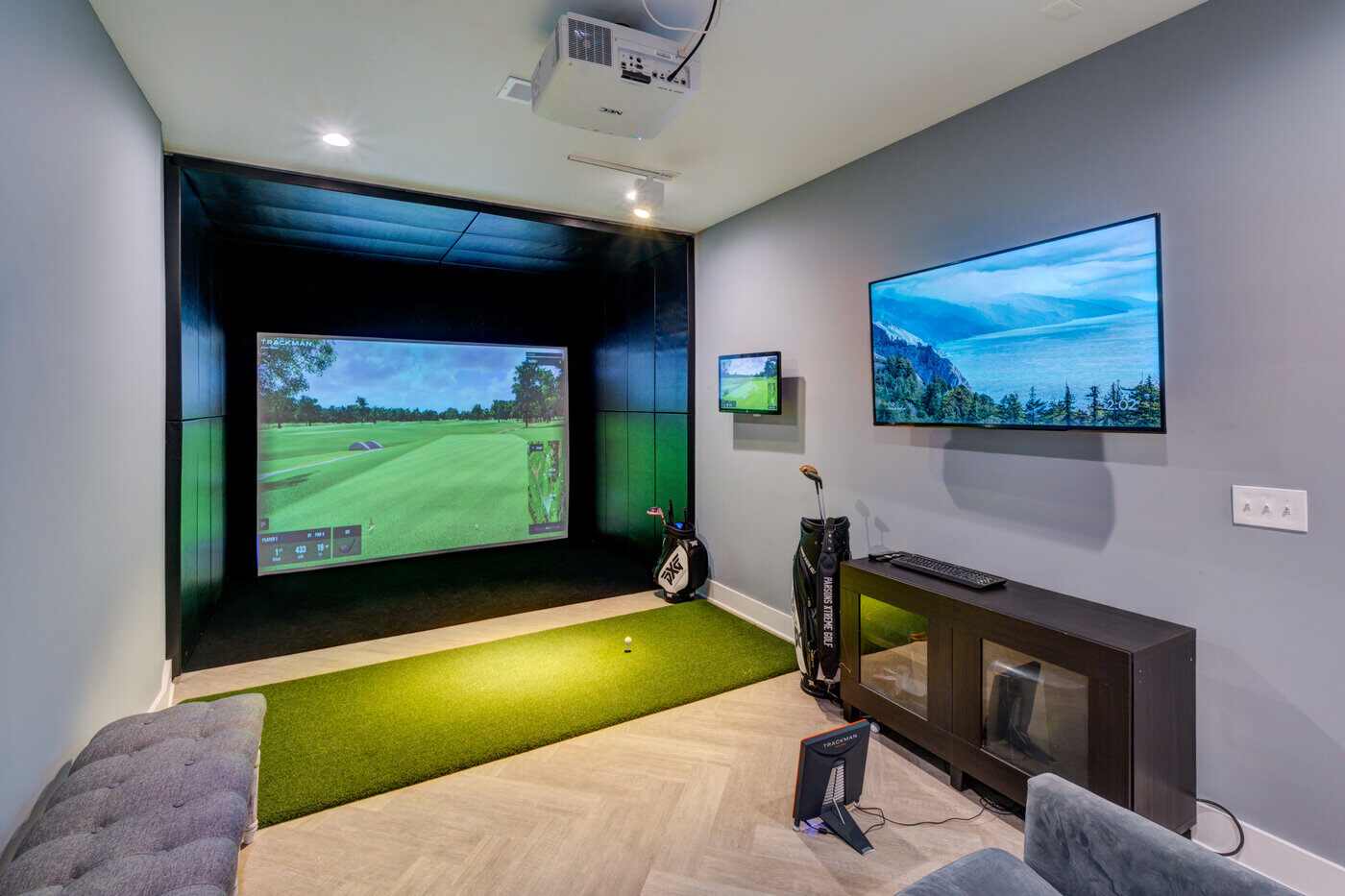 Indoor golf simulator room in Atlanta basement remodel by Silver Oak Remodel