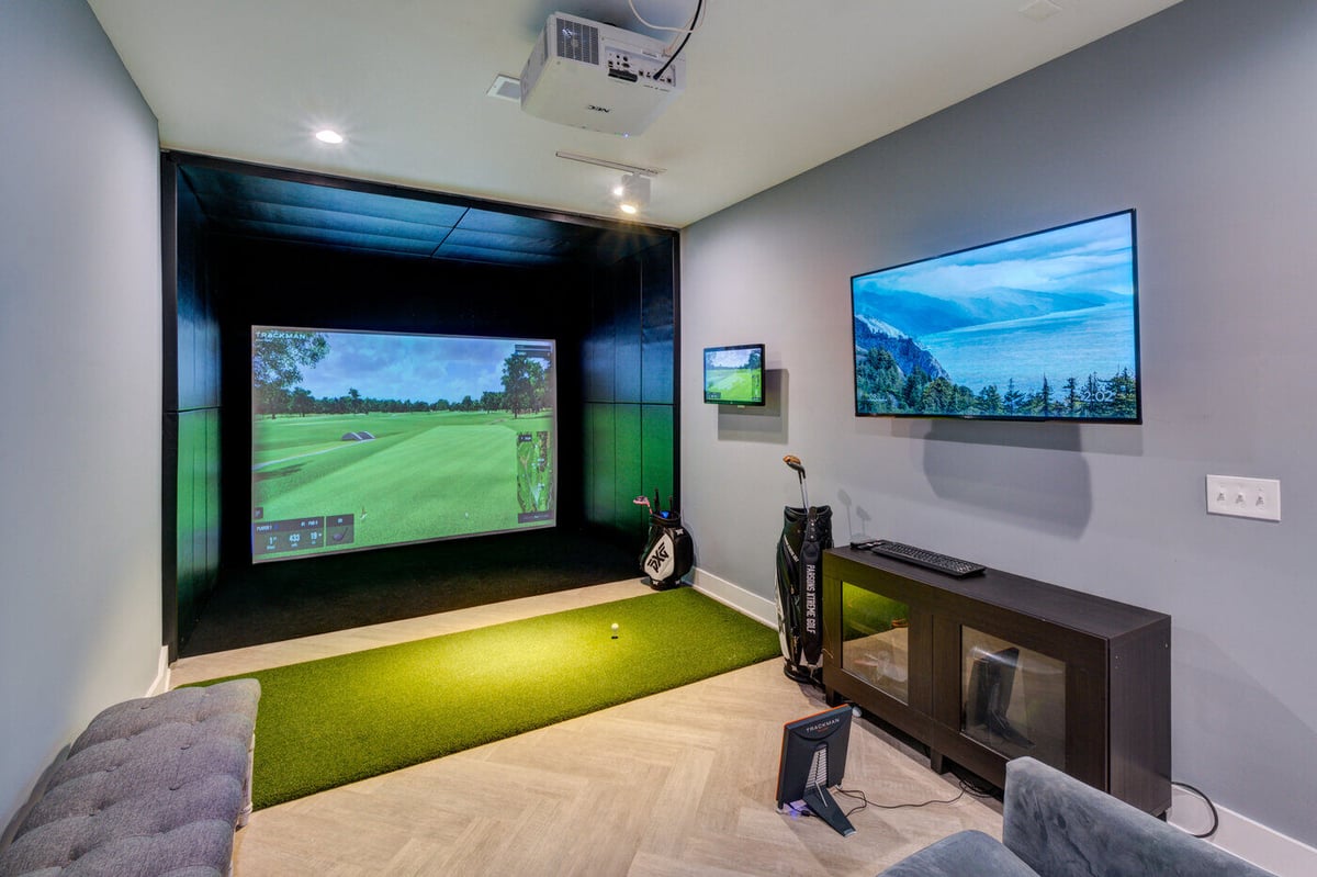 Indoor golf simulator room in Atlanta basement remodel by Silver Oak Remodel