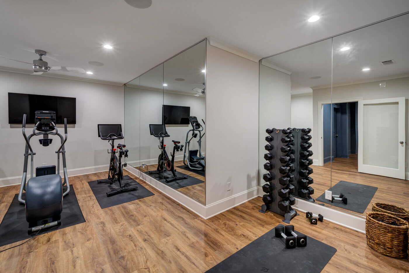 Modern basement bedroom with neutral tones and wood flooring by Silver Oak Remodel in Atlanta, GA