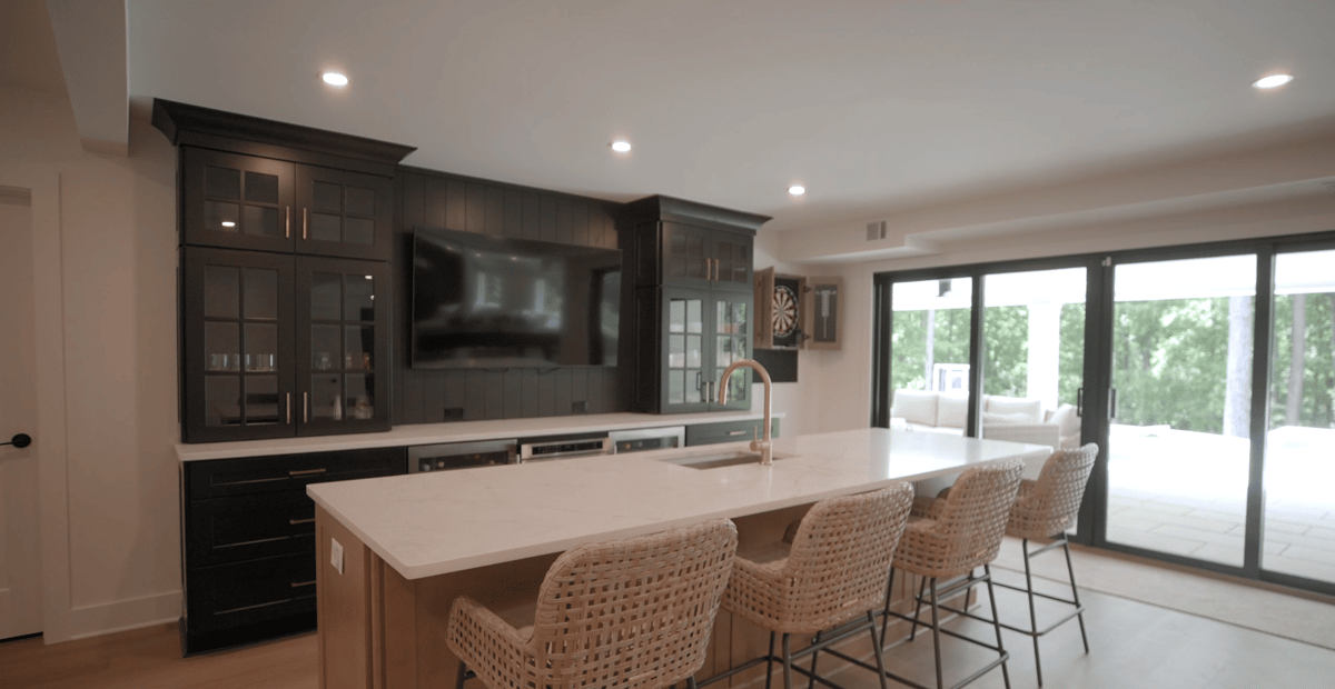 Remodeled Silver Oak basement bar featuring custom cabinetry and spacious island seating in Atlanta, GA.
