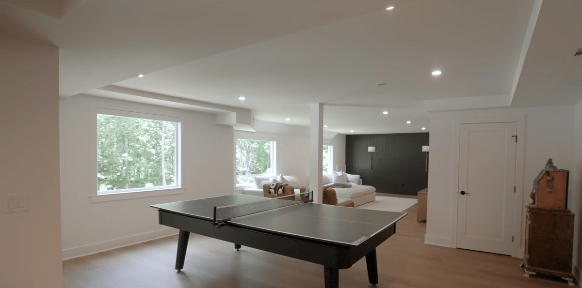 Remodeled Silver Oak basement featuring a bright recreation room and ping pong table in Atlanta, GA.