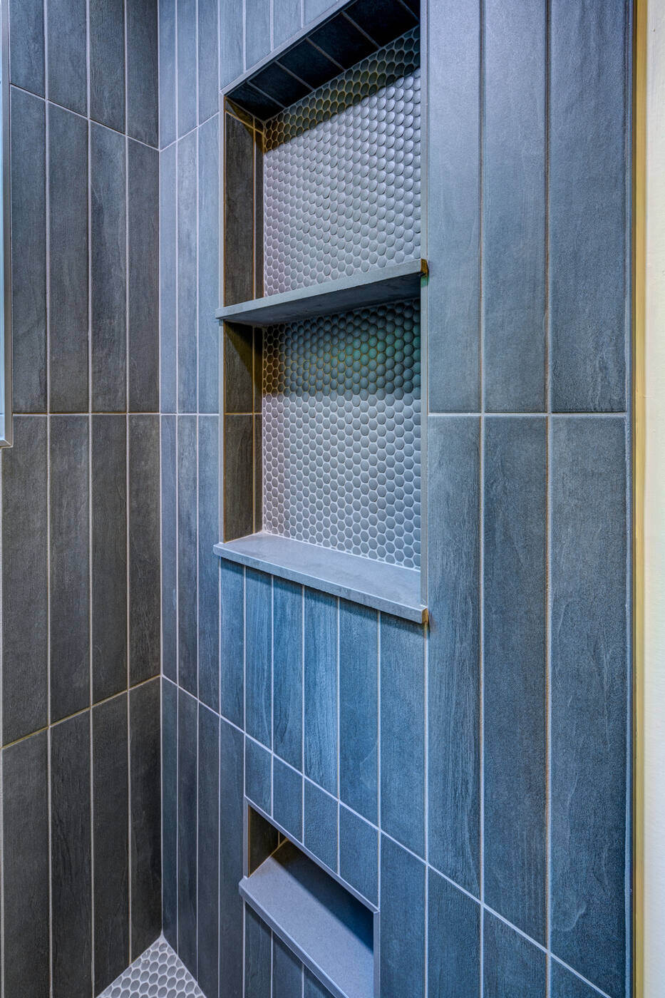 Built-in shower shelf with penny tile accent in Atlanta bathroom remodel by Silver Oak Remodel