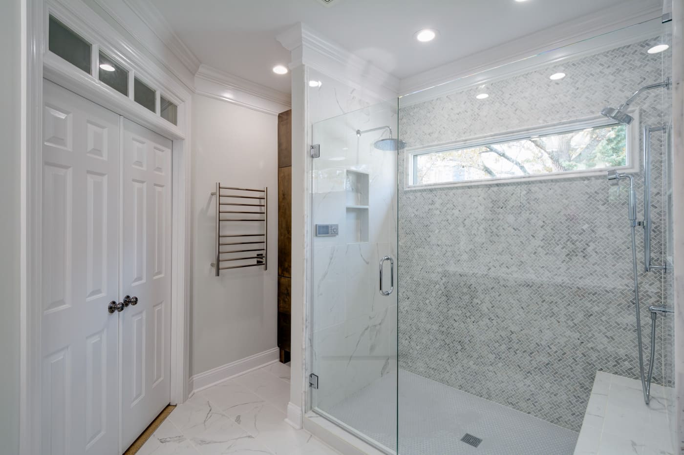 Frameless glass shower with patterned tile wall, part of an Atlanta remodel by Silver Oak Remodeling