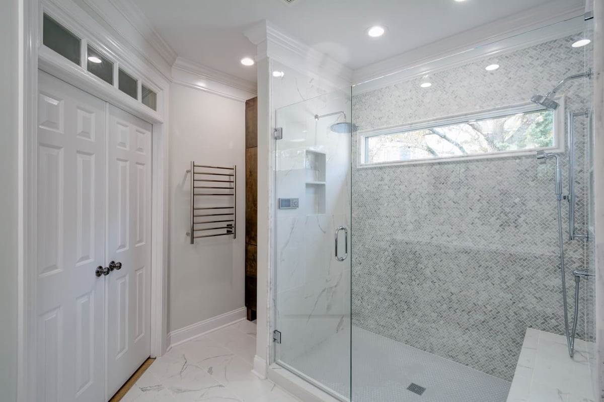 Frameless glass shower with patterned tile wall, part of an Atlanta remodel by Silver Oak Remodeling