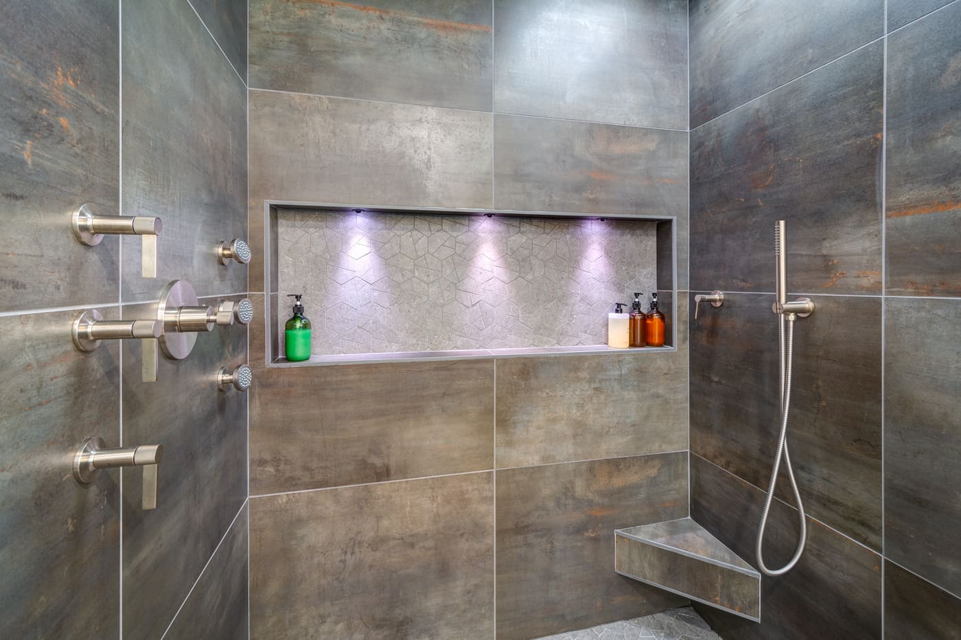 Industrial-style shower with matte fixtures and recessed lighting in an Atlanta bathroom by Silver Oak Remodeling