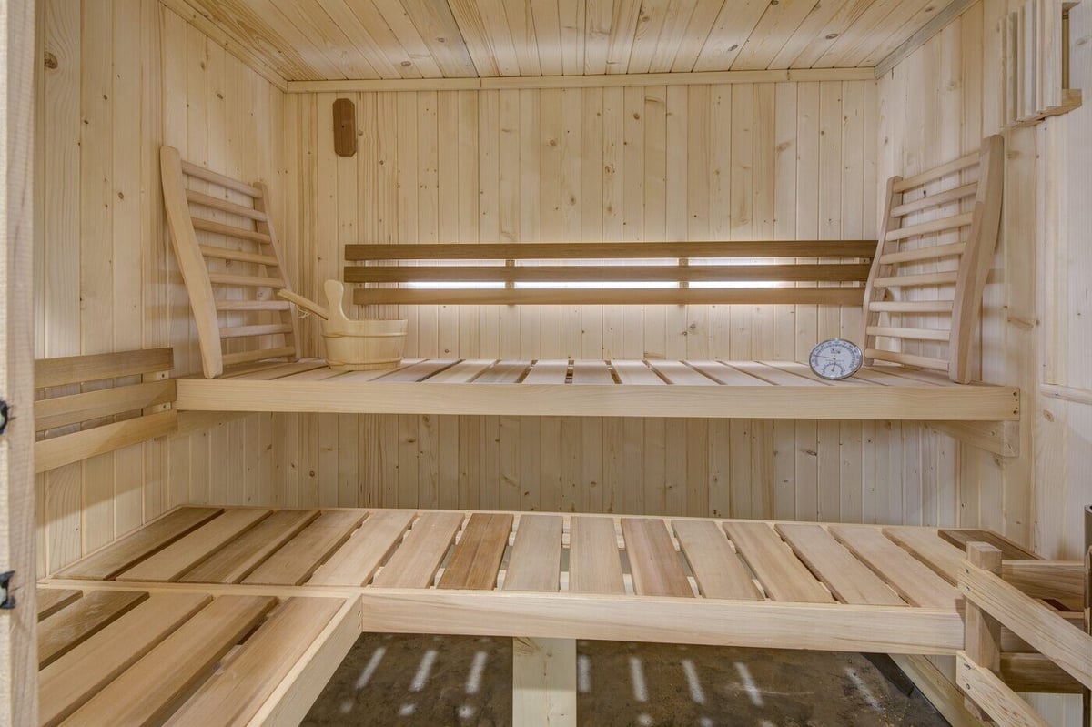 Interior of wood-paneled home sauna with bench seating in Silver Oak Remodels Atlanta project