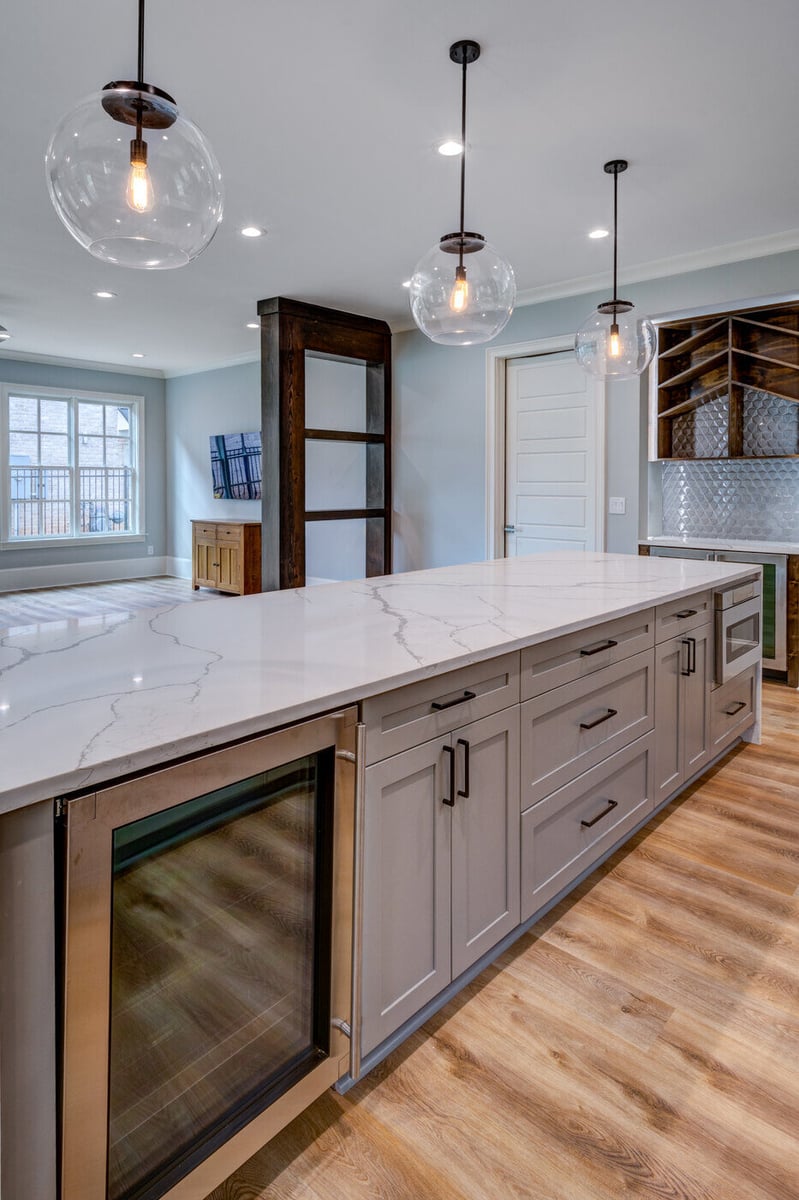 Kitchen island with quartz countertop and pendant lights in a Silver Oak Remodel Atlanta, GA renovation