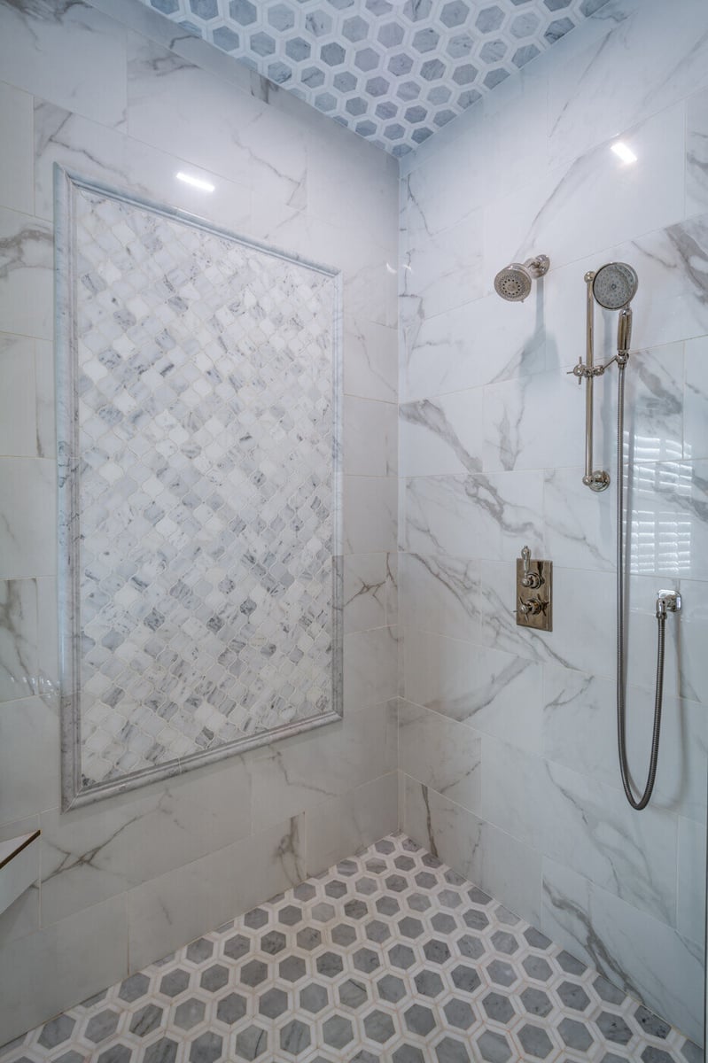 Marble shower with custom mosaic tile accent wall in Atlanta remodel by Silver Oak Remodel