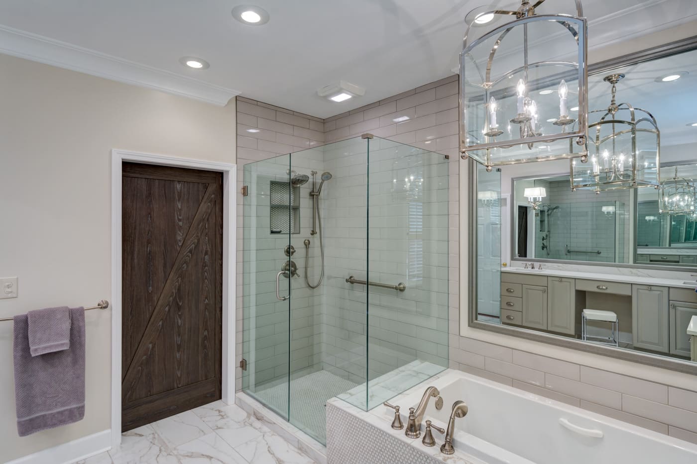 Marble-floor bathroom with glass shower and soaking tub by Silver Oak Remodeling in Atlanta, GA