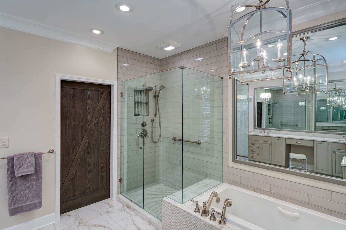 Marble-floor bathroom with glass shower and soaking tub by Silver Oak Remodeling in Atlanta, GA