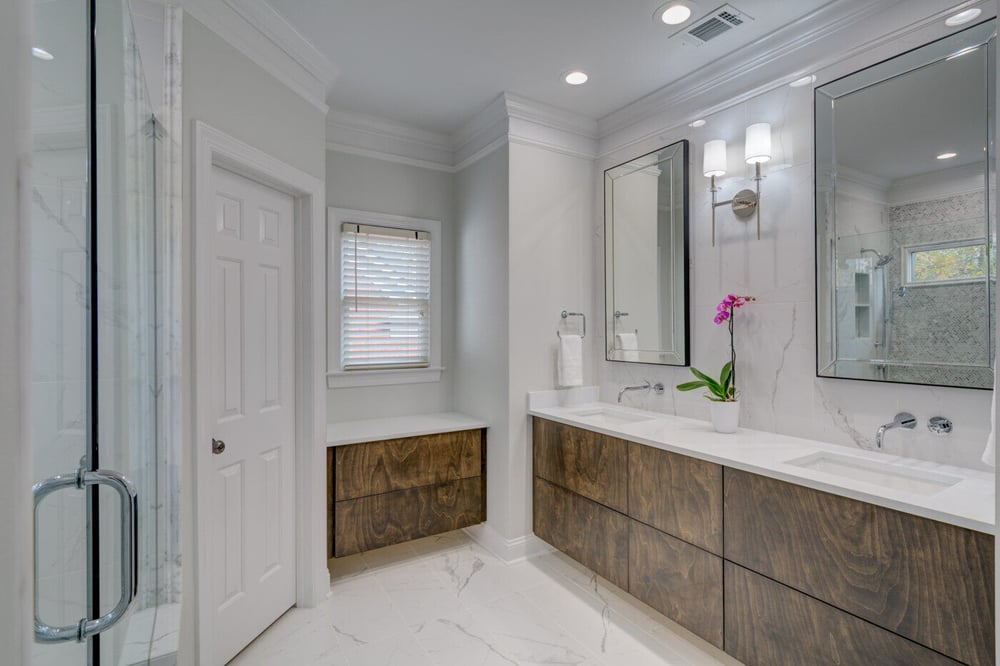 Modern white bathroom with dual vanity and wood cabinetry by Silver Oak Remodel in Atlanta, GA