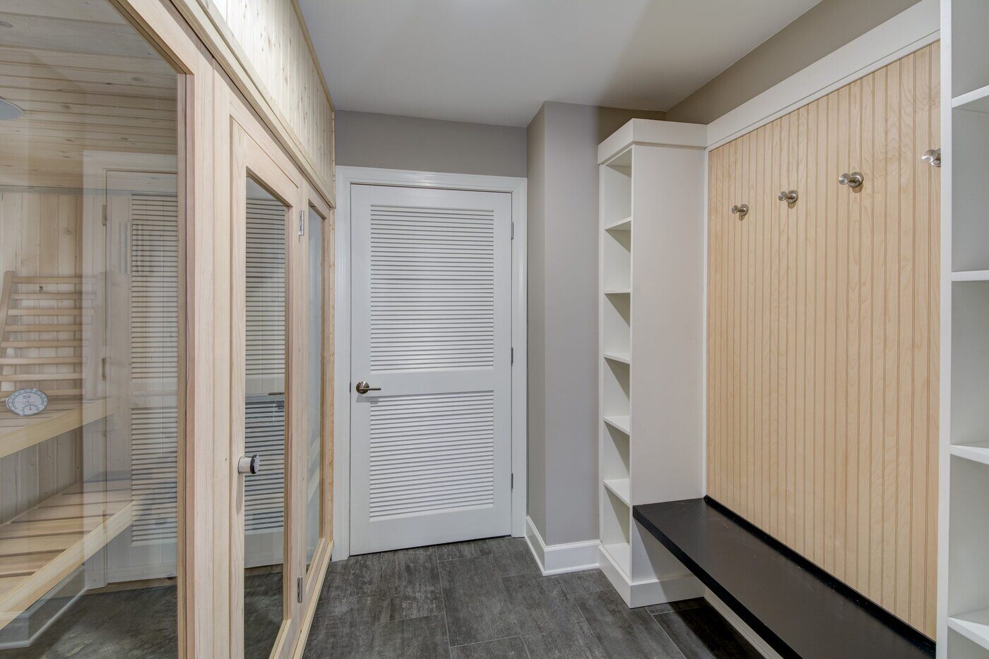 Mudroom with built-in wood sauna and locker storage by Silver Oak Remodel in Atlanta, GA