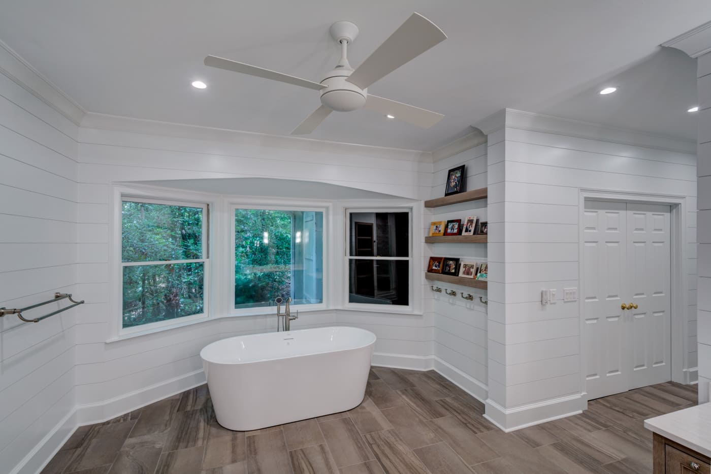 Relaxing bathroom space featuring shiplap walls and wide windows by Silver Oak Remodeling in Atlanta