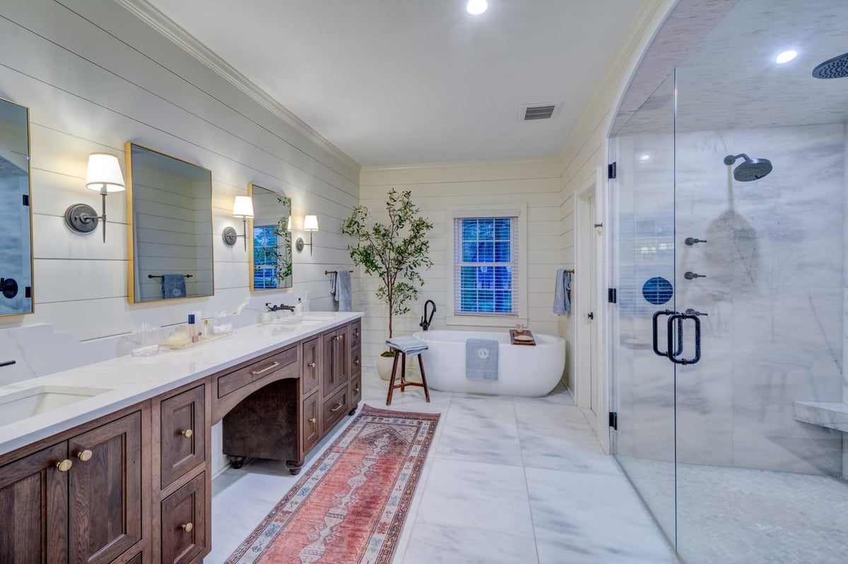 Rustic modern master bathroom with soaking tub and double mirrors, Atlanta build by Silver Oak Remodeling