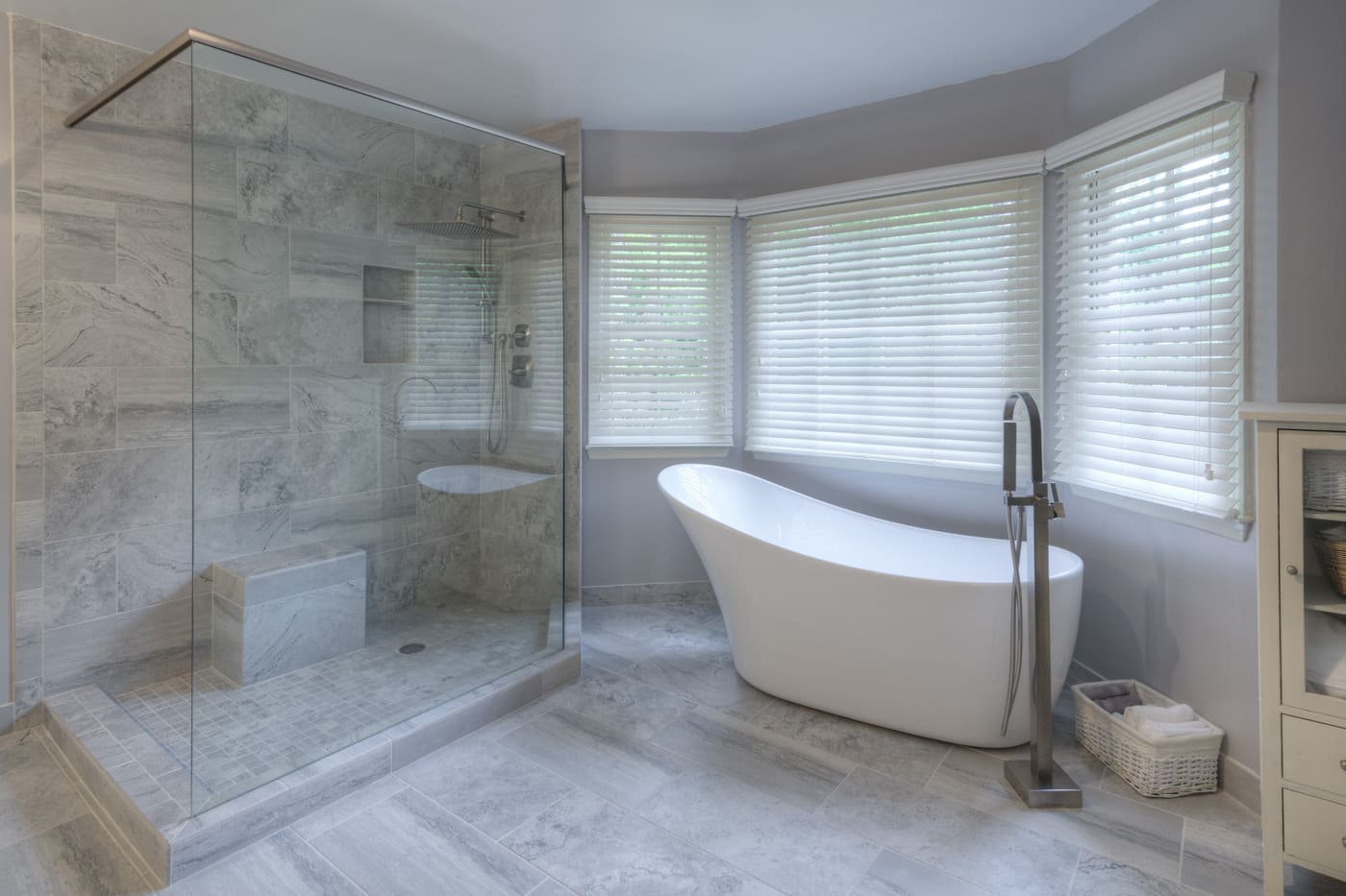 Serene bathroom with large corner tub and gray tile shower by Silver Oak Remodeling in Atlanta, GA