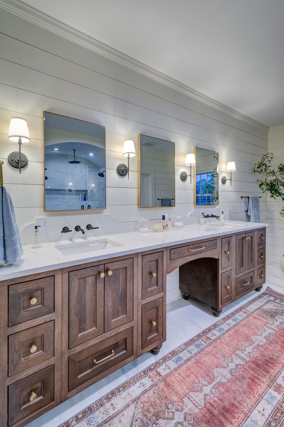 Double vanity with rustic wood cabinetry and modern mirrors in an Atlanta custom home by Silver Oak Remodeling