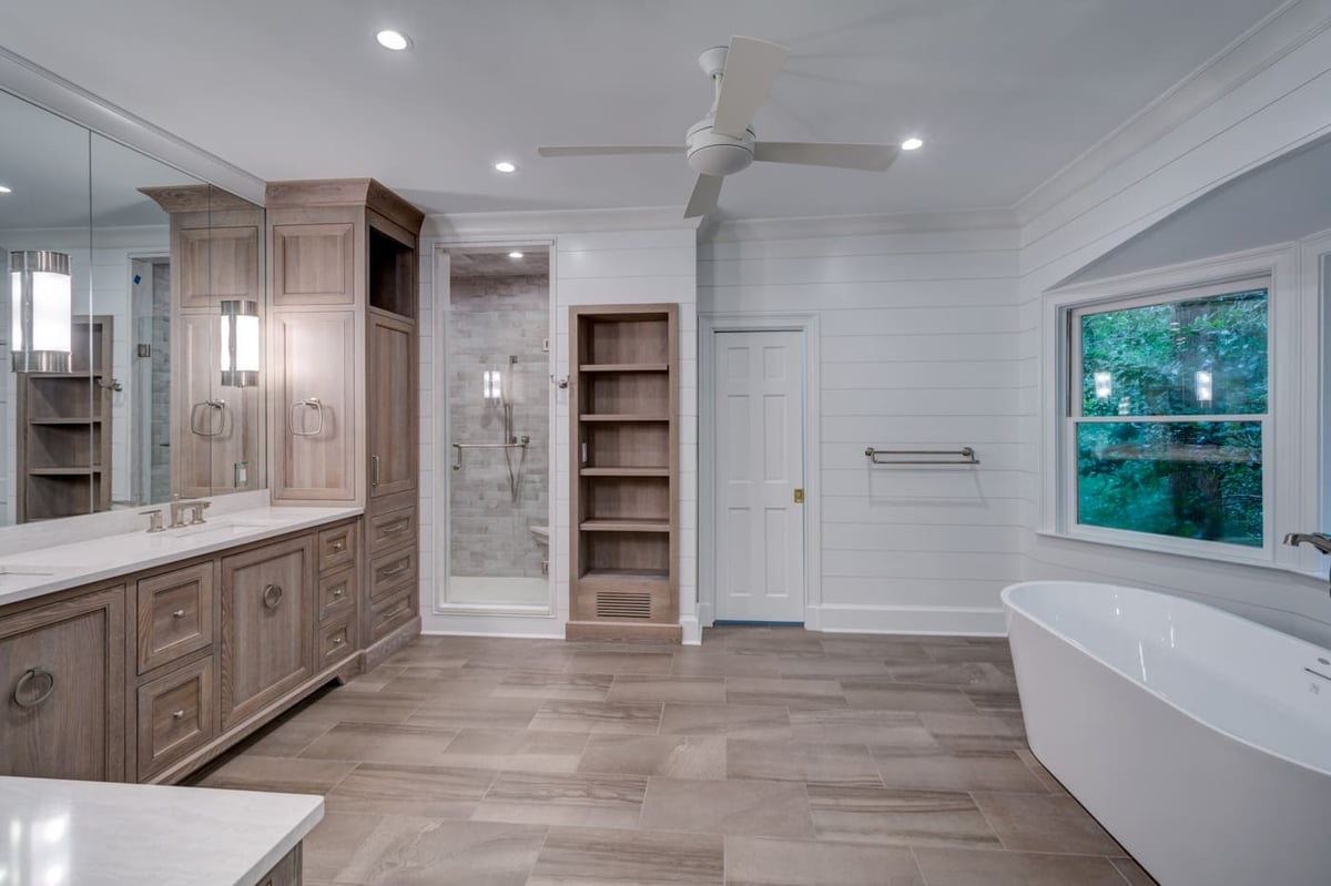 Neutral-toned bathroom with wood vanity and walk-in shower by Silver Oak Remodeling in Atlanta, GA