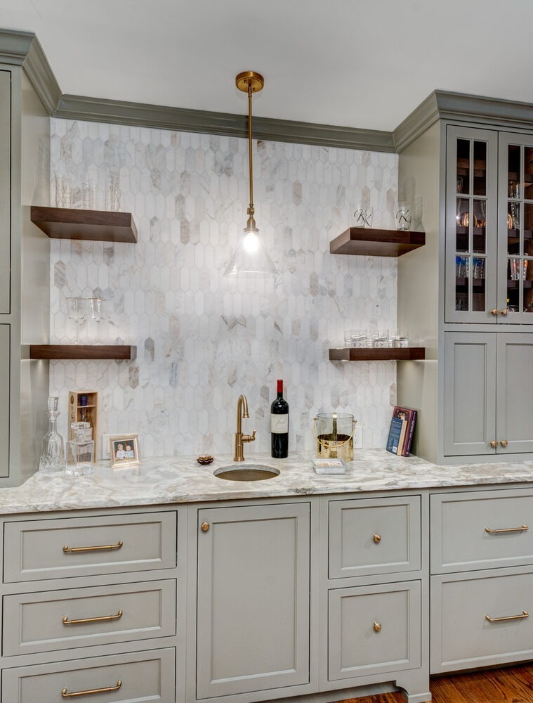Built-in bar area with marble countertop and glass cabinets by Silver Oak in Roswell, GA
