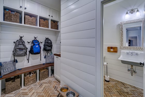 Organized mudroom with shiplap walls and brick floor completed by Silver Oak in Roswell, GA