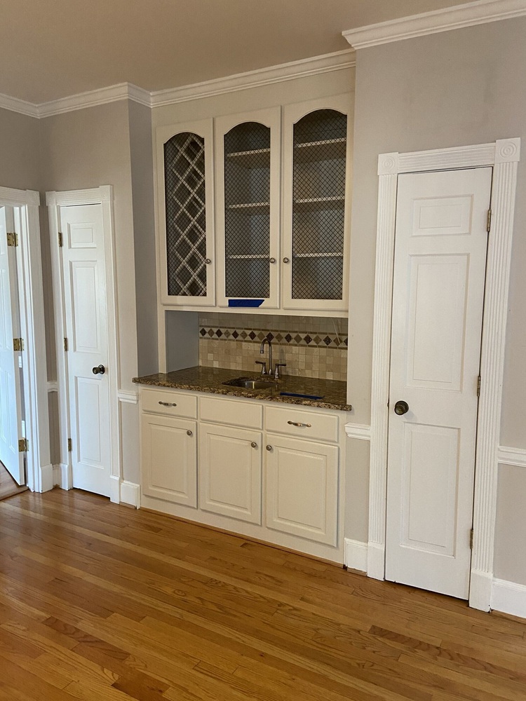 Original home bar with wire mesh cabinet doors and granite countertops before Silver Oak remodel in Roswell, GA