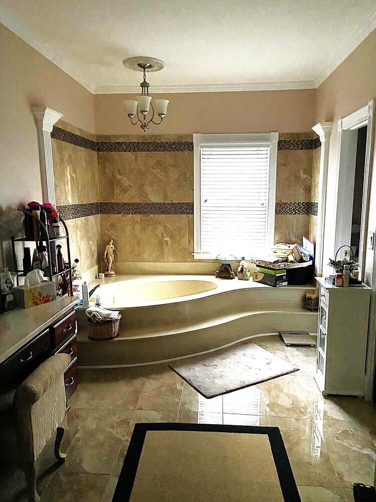 Outdated bathroom with step-up tub and tan tile before Silver Oak remodel in Roswell, GA