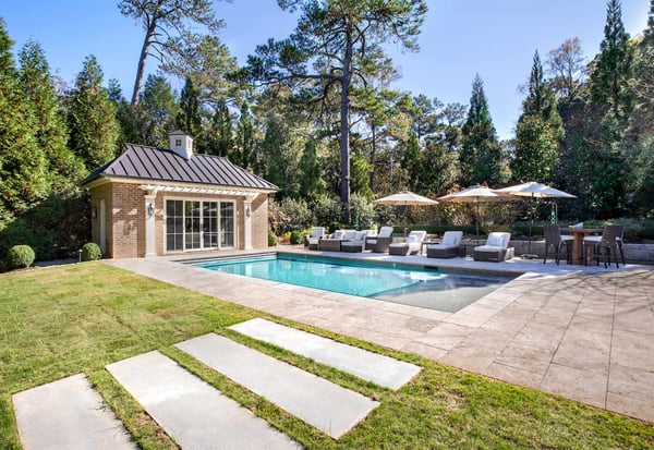Backyard pool with lounge area and custom cabana in Atlanta, GA by Silver Oak Remodel