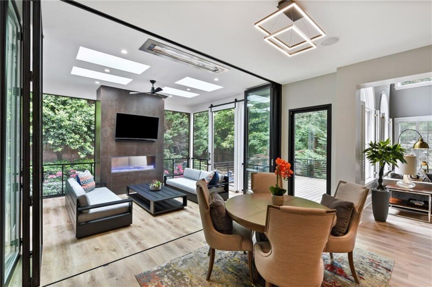 Bright screened porch with skylights and modern fireplace designed by Silver Oak Remodel in Atlanta, GA